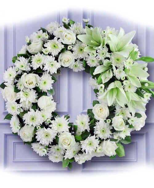 White lillies chysanthimum roses round wreath arrangement